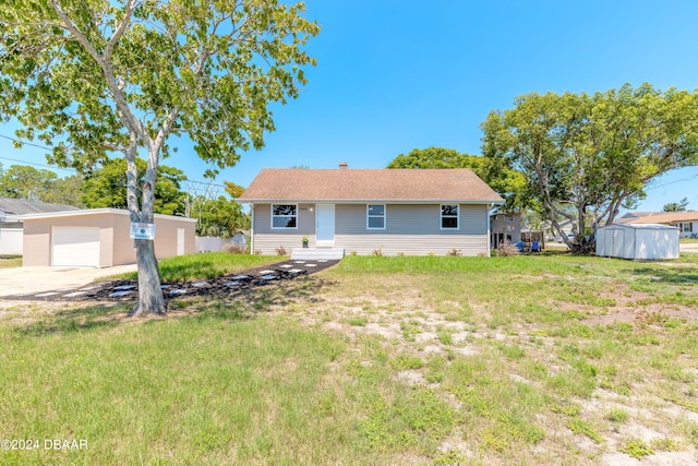 back of property featuring a shed and a lawn