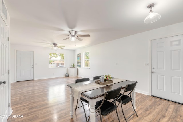 dining space with wood-type flooring and ceiling fan