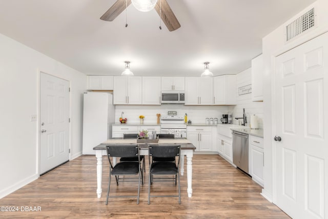 kitchen featuring stainless steel appliances, light hardwood / wood-style floors, white cabinetry, and sink