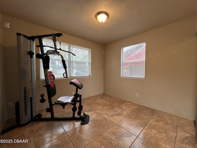 workout room with a textured ceiling