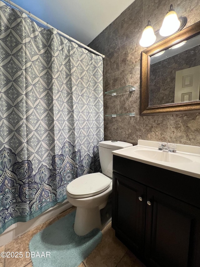 full bath with decorative backsplash, toilet, tile patterned floors, vanity, and tile walls