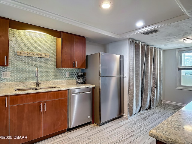 3333 S Atlantic Ave Unit 605, Daytona Beach, FL 32118 - kitchen featuring a sink, appliances with stainless steel finishes, backsplash, wood finish floors, and light stone counters