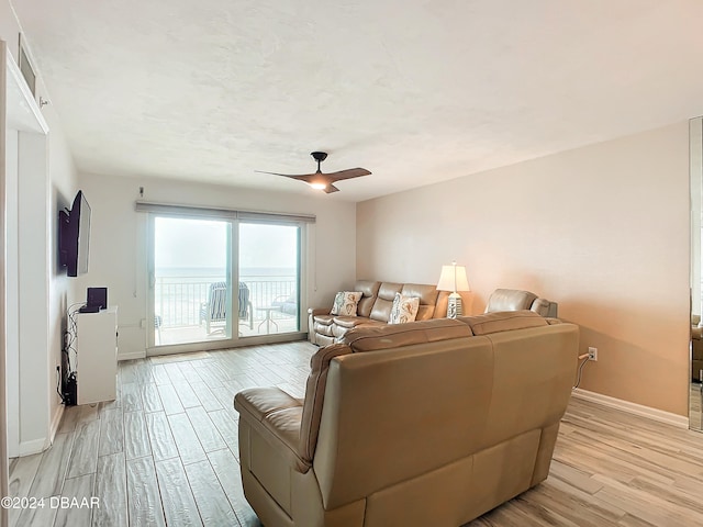 living room with light wood-type flooring and ceiling fan