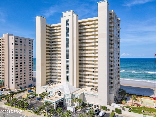 view of property with a view of the beach and a water view