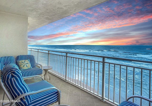 3333 S Atlantic Ave Unit 605, Daytona Beach, FL 32118 - balcony at dusk featuring view of water and beach