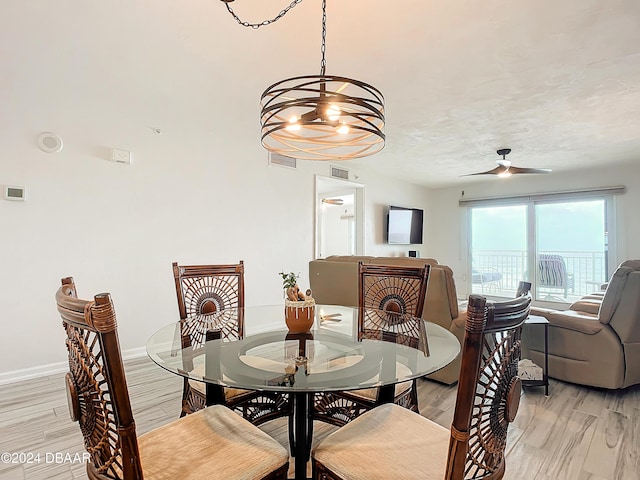 3333 S Atlantic Ave Unit 605, Daytona Beach, FL 32118 - dining space with light wood-style floors, baseboards, a chandelier, and a ceiling fan
