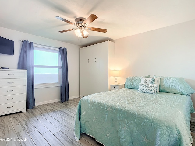 bedroom with ceiling fan and light hardwood / wood-style flooring