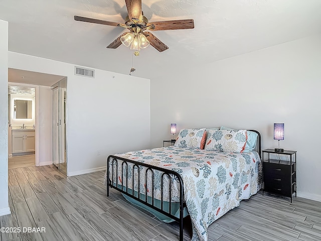 3333 S Atlantic Ave Unit 605, Daytona Beach, FL 32118 - bedroom with wood tiled floors, baseboards, a ceiling fan, and a sink