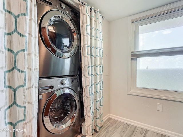 3333 S Atlantic Ave Unit 605, Daytona Beach, FL 32118 - laundry area with stacked washer / drying machine and baseboards