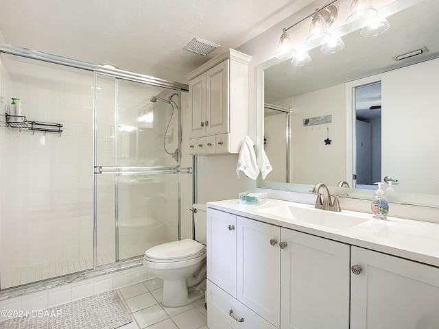 bathroom with walk in shower, vanity, toilet, and tile patterned flooring