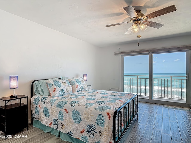 3333 S Atlantic Ave Unit 605, Daytona Beach, FL 32118 - bedroom featuring wood finished floors, access to outside, a water view, and a ceiling fan