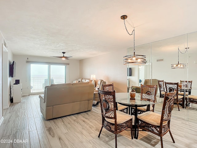 dining space featuring light wood-type flooring and ceiling fan