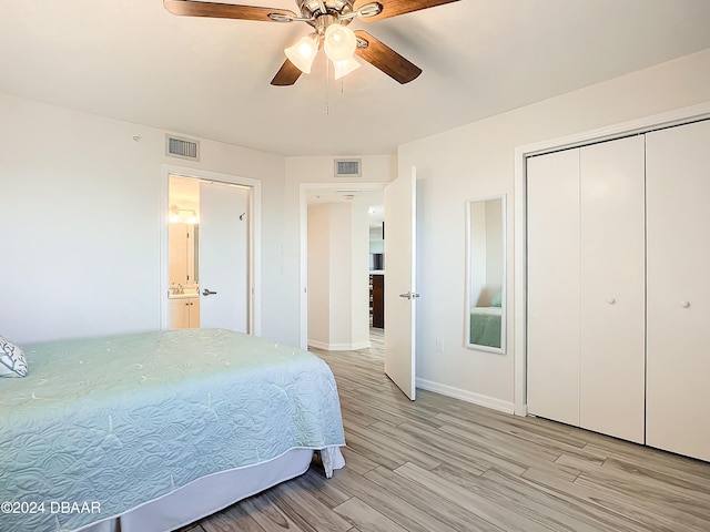 bedroom featuring light wood-type flooring, ceiling fan, and a closet