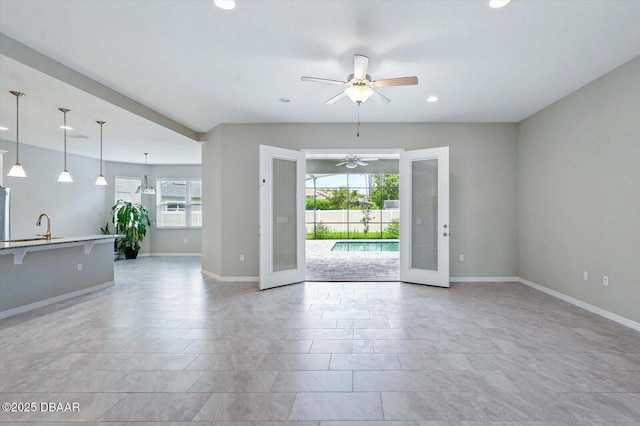 25 Egret Trl, Palm Coast, FL 32164 - unfurnished living room featuring ceiling fan, plenty of natural light, and recessed lighting