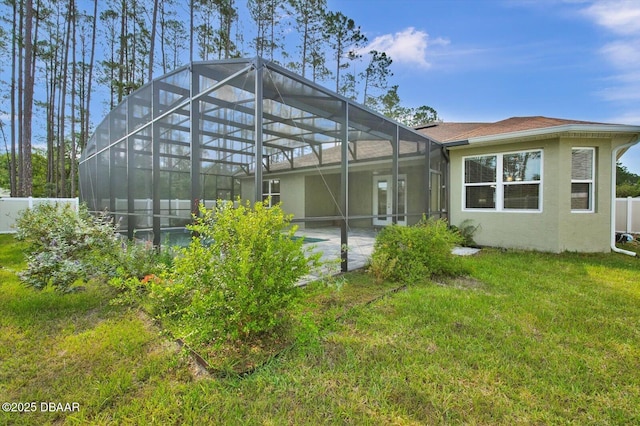 25 Egret Trl, Palm Coast, FL 32164 - back of property with stucco siding, glass enclosure, and a shingled roof