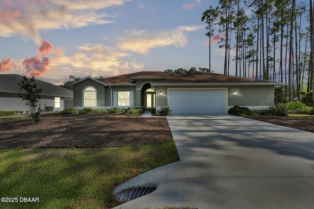25 Egret Trl, Palm Coast, FL 32164 - ranch-style home with an attached garage, concrete driveway, and stucco siding
