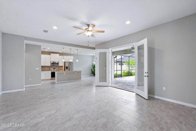 25 Egret Trl, Palm Coast, FL 32164 - unfurnished living room with a ceiling fan, french doors, and recessed lighting