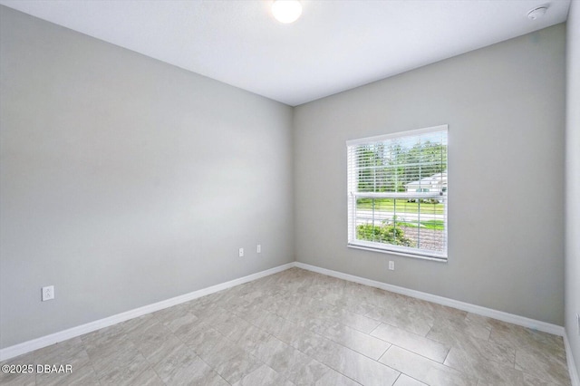 25 Egret Trl, Palm Coast, FL 32164 - empty room with a smoke detector and light tile patterned floors