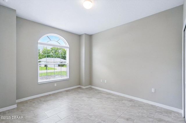 25 Egret Trl, Palm Coast, FL 32164 - spare room featuring baseboards and light tile patterned floors