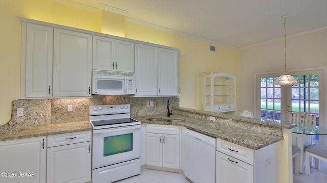 kitchen with white cabinetry, kitchen peninsula, white appliances, french doors, and sink