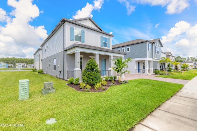 view of front of property featuring covered porch and a front yard