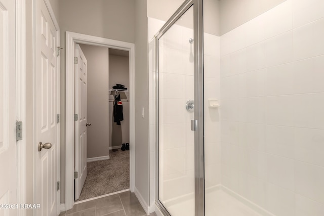 bathroom featuring walk in shower and tile patterned flooring