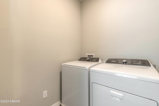 clothes washing area with washing machine and clothes dryer