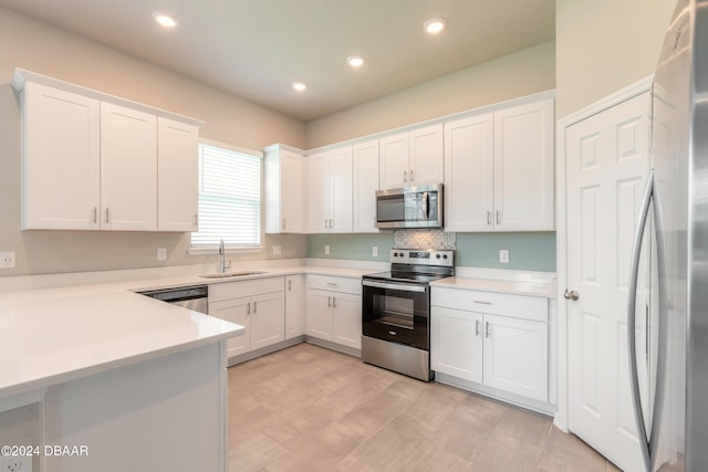 kitchen featuring white cabinets, sink, and stainless steel appliances