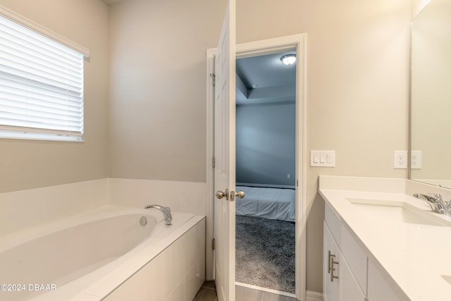 bathroom with vanity and a tub