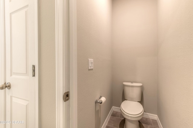 bathroom with toilet and tile patterned floors