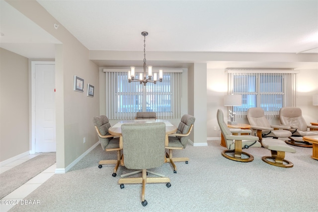 dining area featuring a notable chandelier and light carpet