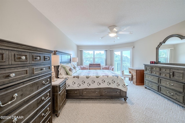 bedroom with a textured ceiling, light colored carpet, ceiling fan, and lofted ceiling