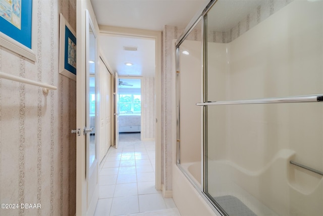 bathroom featuring tile patterned flooring and enclosed tub / shower combo