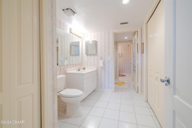 bathroom featuring tile patterned flooring, vanity, and toilet