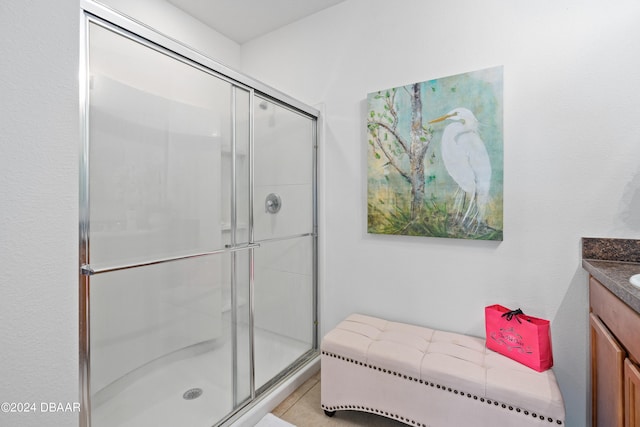 bathroom with walk in shower and vanity