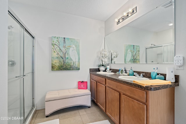 bathroom with vanity, tile patterned flooring, a textured ceiling, and an enclosed shower