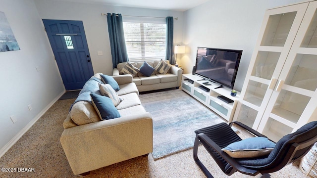 living room with speckled floor and baseboards