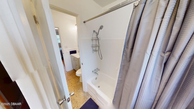 bathroom featuring speckled floor, toilet, shower / bath combo, and vanity