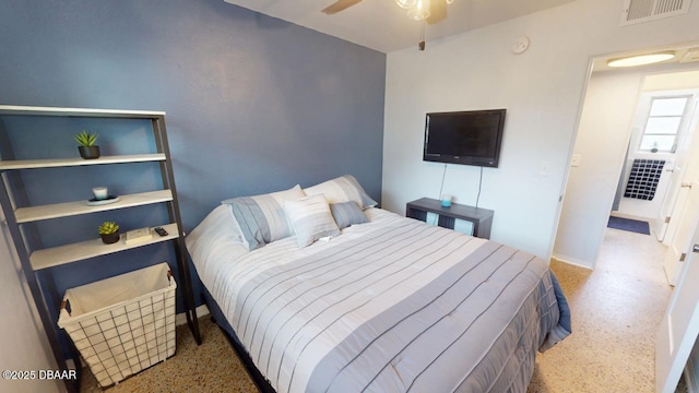 bedroom with ceiling fan, visible vents, and speckled floor