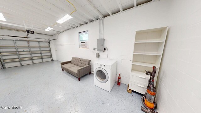 garage with electric panel, washer / clothes dryer, and a garage door opener