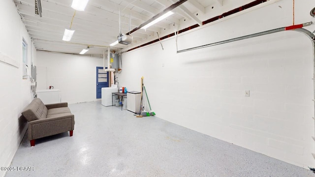 garage featuring a garage door opener and water heater