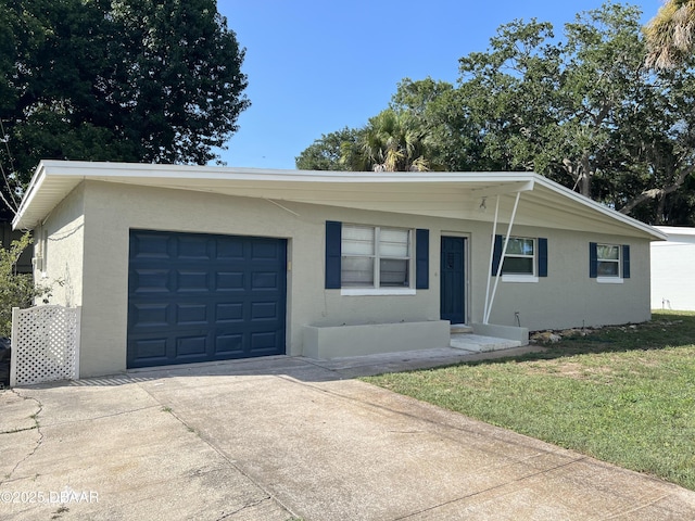 ranch-style house featuring stucco siding, concrete driveway, a garage, and a front yard