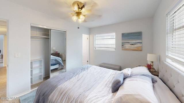 carpeted bedroom featuring a closet and ceiling fan