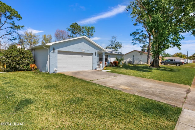 view of front of house with a garage and a front lawn