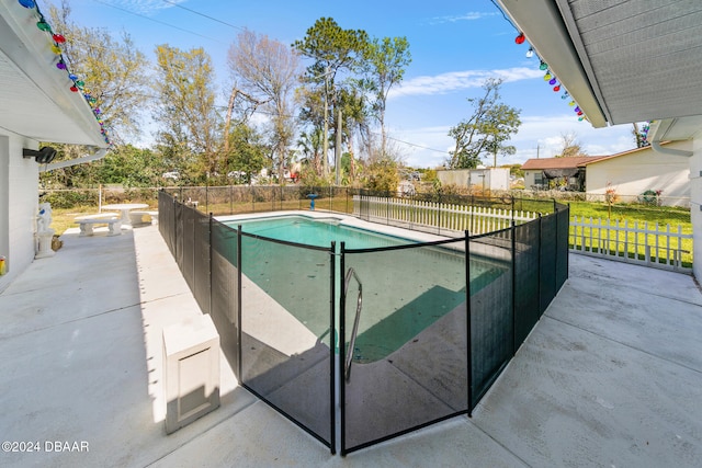 view of swimming pool featuring a patio area