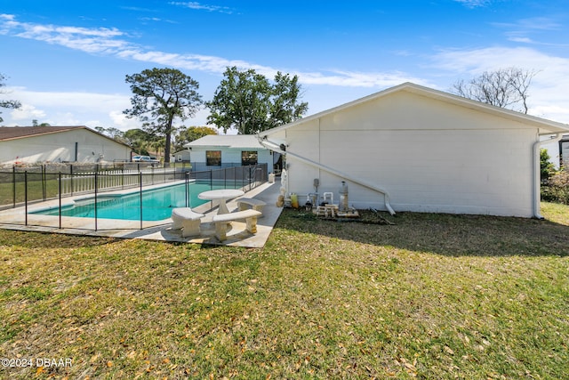 view of swimming pool with a patio and a yard