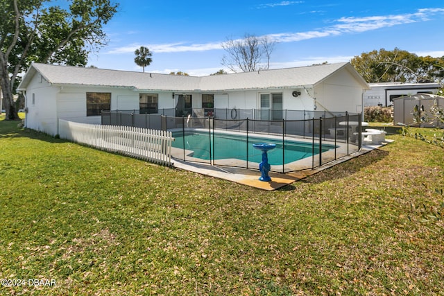 view of swimming pool featuring a storage shed and a lawn