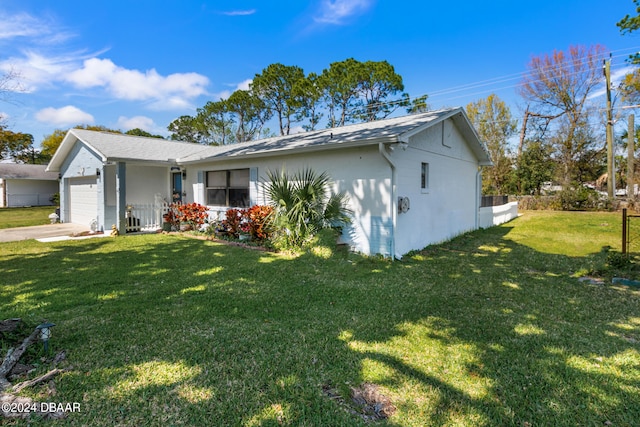 view of front of property with a garage and a front yard