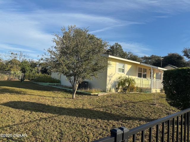 view of home's exterior featuring a lawn and a porch