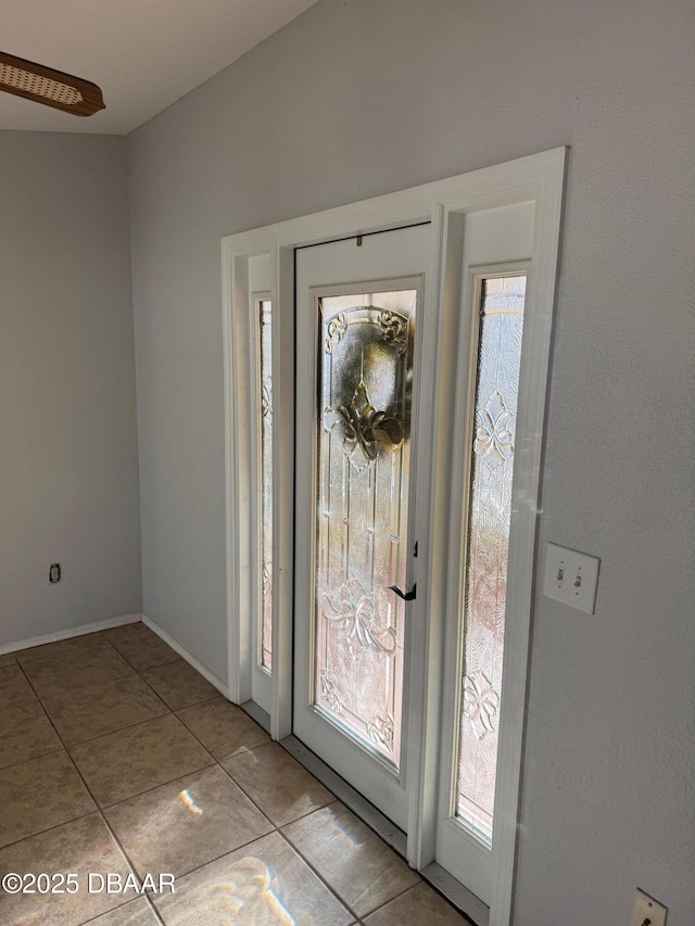 entryway with light tile patterned flooring